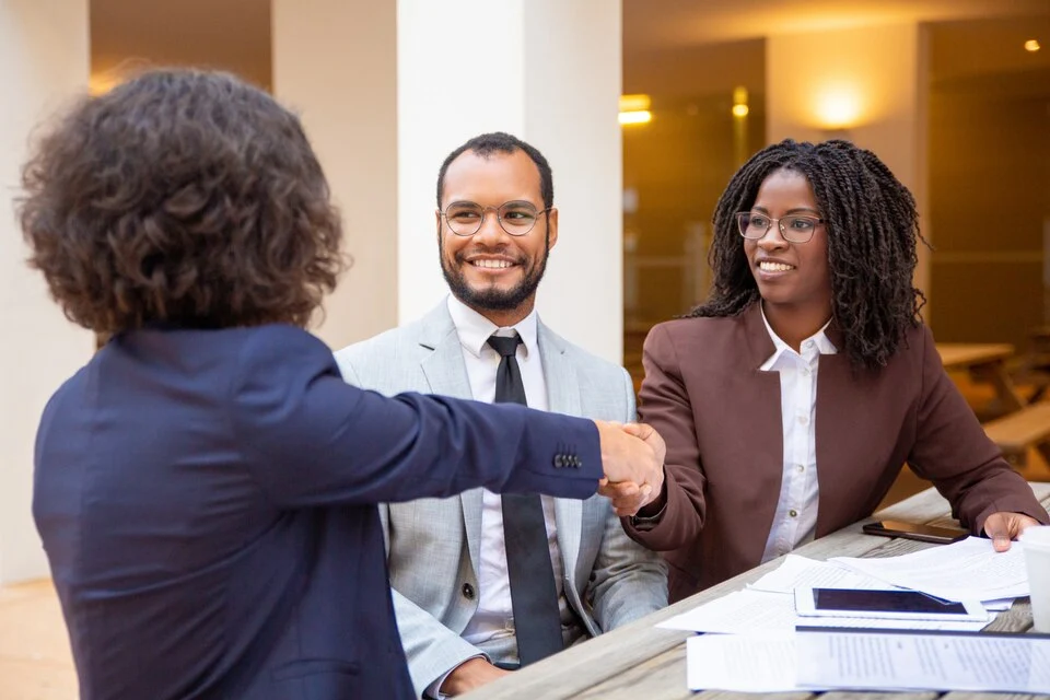 Mergers and Acquisition Consulting Consultants shaking hands with a client