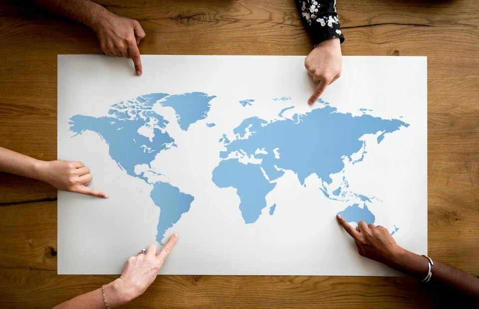 A team of business proffesionals looking at a world map depicting International Business Consulting