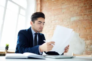 Image depicting a corporate professional analysing documents of their recent Mergers and Acquisitions in India