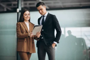Image depicting two business professionals having a chat over Mergers and Acquisitions in India